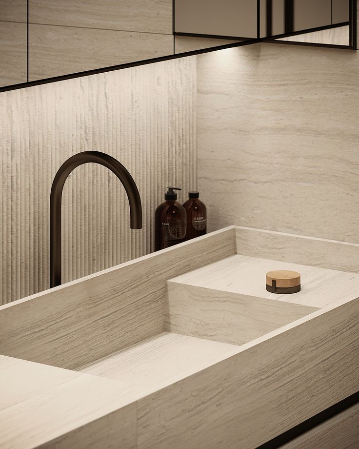 a bathroom sink sitting under a mirror next to a faucet and soap dispenser