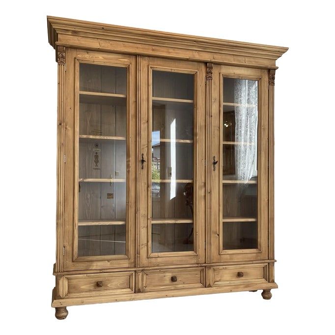 an old wooden china cabinet with glass doors on the top and bottom shelves, in front of a white background