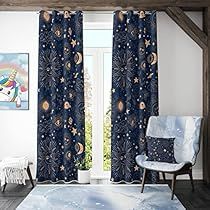 a living room filled with furniture and a window covered in blue drapes next to a white chair