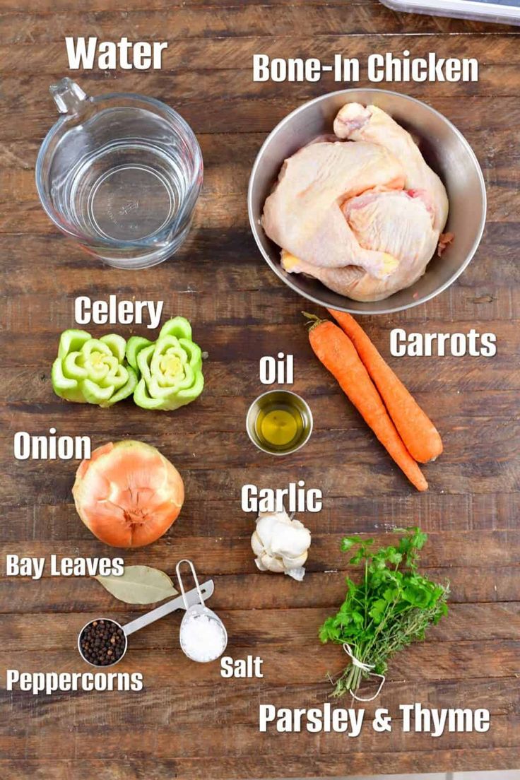 the ingredients to make chicken broth on a wooden table