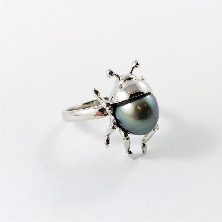 Beetle bug insect Tahitian pearl 14k white gold ring Size 6.5 US - Ready to ship or resizeThis is a baroque shaped Tahitian pearl Set in solid 14k white gold.Ring specifications:• Ring size is 6.5 US, but can be resized. Please be aware that if you choose to resize than the lead time is 2-3 weeks. Choose your size from the drop down menu.• Baroque shaped Tahitian pearl 1.08gr 10.80x8.86mm.• Solid 14k white gold.• Head including accent stones 20.09x13.40x10.17mm.• Band width approximately 2.40mm. Bug Rings, Bug Clothes, Beetle Ring, Bug Ring, Bug Jewelry, Beetle Bug, Insect Jewelry, Bugs And Insects, Funky Jewelry