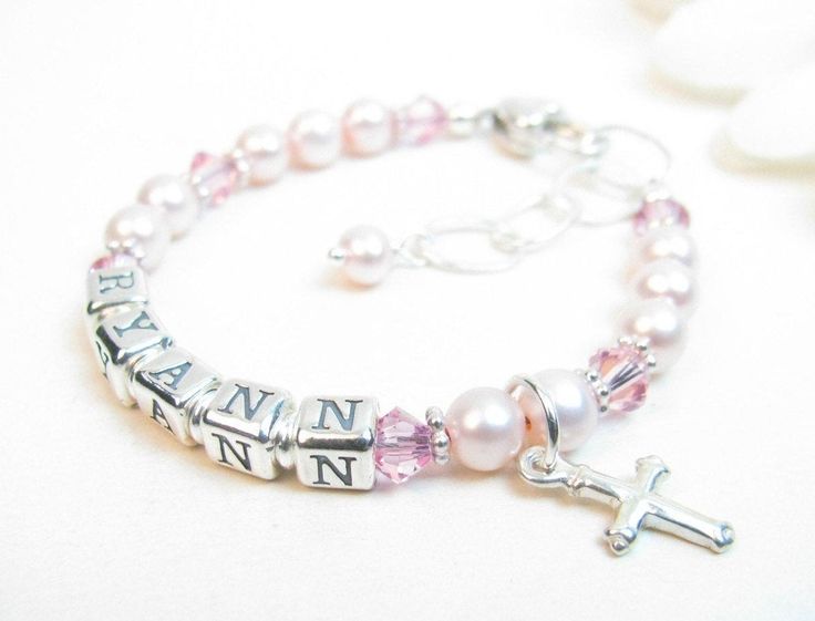 "Pink Beaded Name Bracelet for Child, Infant, Baby, or Little Girl: Created with pink Swarovski pearls and crystals and bright sterling silver spacers. Petite sterling silver alphabet beads spell out her name. The bracelet closes with a high-quality sterling silver heart-shaped lobster clasp with a 1/2\" \"Grow-with-Me\" extender chain. Choose one sterling silver charm. All metal components are sterling silver. Arrives packaged in my signature high-quality reusable canvas gift bag. Beautiful and Adjustable Pink Rosary Bracelet For First Communion, Personalized Pink Pearl Bracelet For Birthday, Pink Beaded Jewelry For First Communion, Adjustable Pink Jewelry For Baptism, Pink Beaded Jewelry For Baptism, Pink Pearl Beaded Bracelet For Birthday, Pink Pearl Bracelet For Birthday, Personalized Pink Rosary Bracelet For Baptism, Personalized Pink Pearl Bracelet With Round Beads