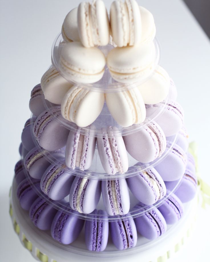 there is a cake that has many different types of macaroons on top of it