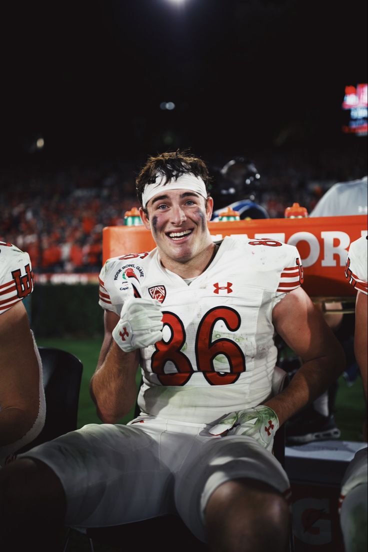 a football player is sitting on the bench