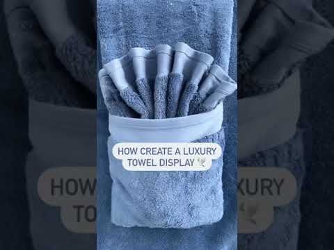 there is a towel that has been folded up in a pocket with the words how create a luxury towel display on it