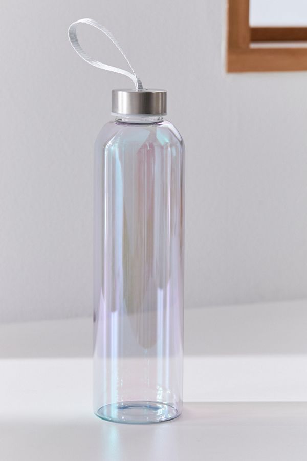 a clear water bottle sitting on top of a white table next to a framed mirror