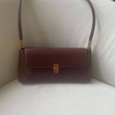 Get ready for fall with the must-have Audrey Bag! Its retro and classic design exudes chic style and will elevate any outfit. PU leather Imported Color: Burgundy Gold buckle and accents Approximate measurements: 11x4.7 in (Handle:10.62") Classic Baguette Bag With Detachable Handle, Retro Everyday Bags With Gold-tone Hardware, Vintage Crossbody Baguette Bag, Classic Satchel Baguette Bag With Detachable Strap, Classic Baguette Satchel Bag With Detachable Strap, Retro Everyday Satchel With Gold-tone Hardware, Retro Satchel With Gold-tone Hardware For Daily Use, Vintage Crossbody Baguette Bag With Detachable Strap, Classic Satchel Baguette Bag For Business