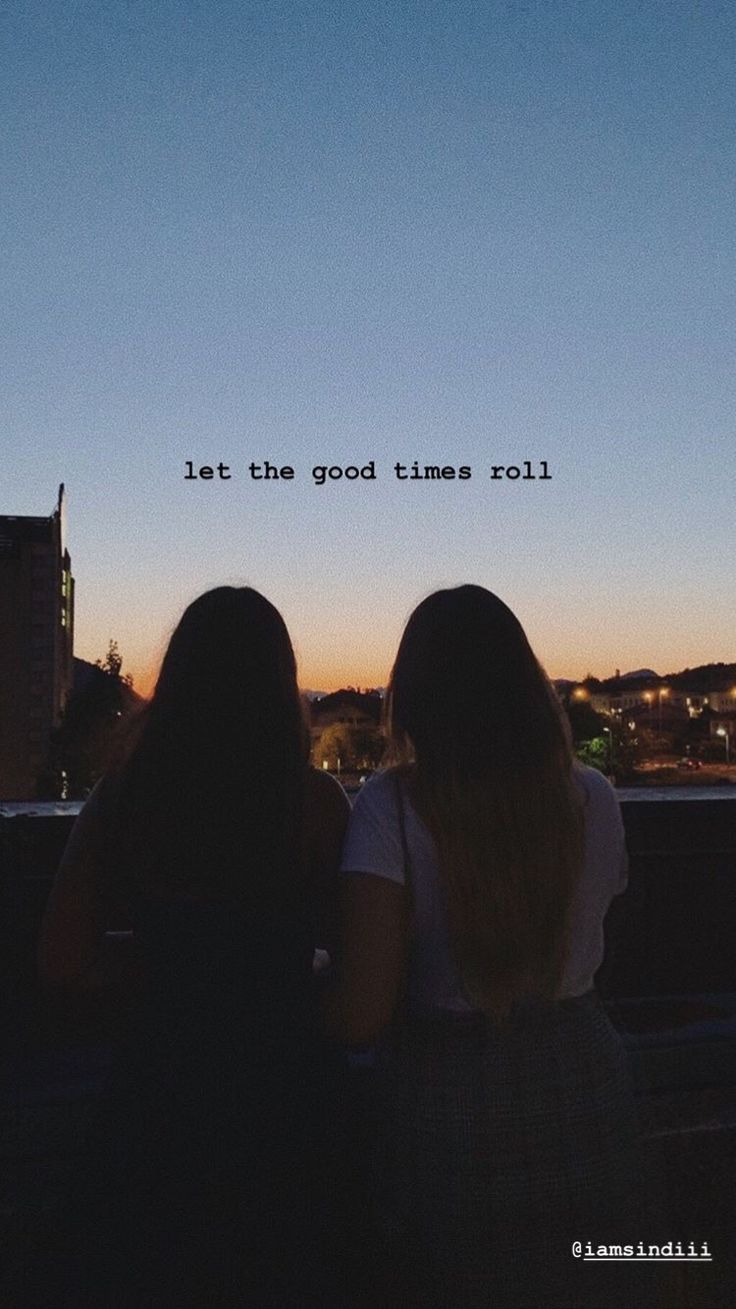 two women sitting on top of a roof with the words let the good times roll