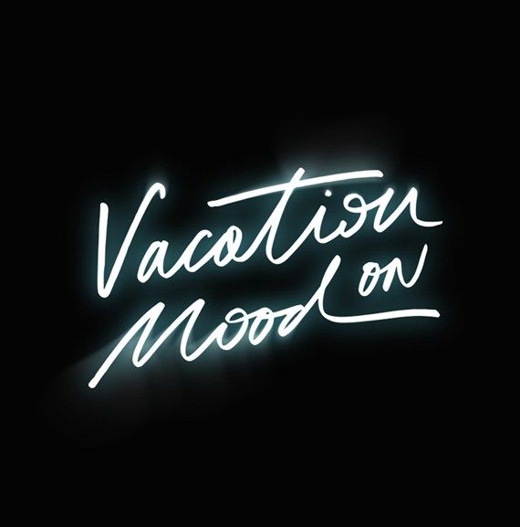 a neon sign that reads vacation on mood