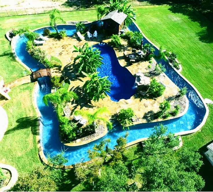 an aerial view of a pool surrounded by palm trees