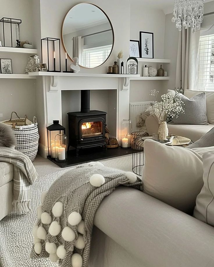 a living room filled with furniture and a fire place next to a mirror on the wall