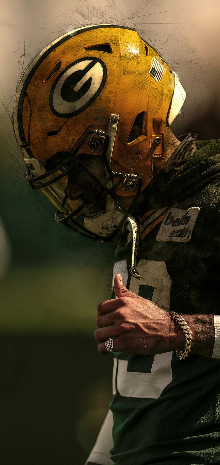 a close up of a football player wearing a green bay packers uniform with his hand on his hip