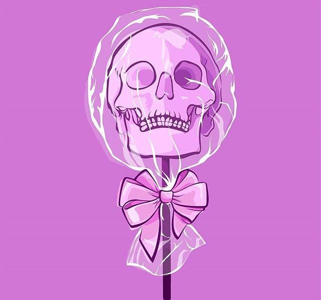 a purple lollipop with a skull on it and a bow around the neck