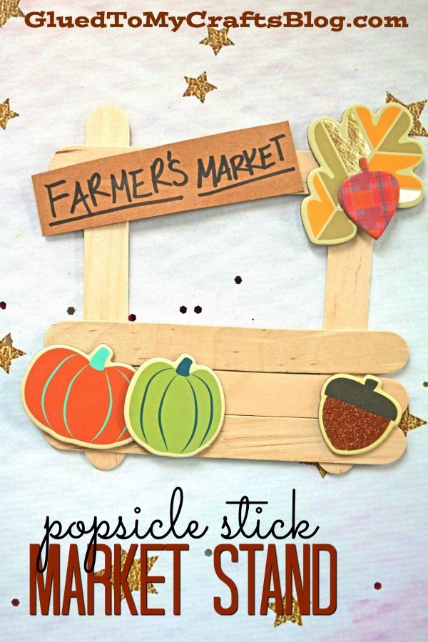 a wooden sign that says farmers market with pumpkins and acorns on it