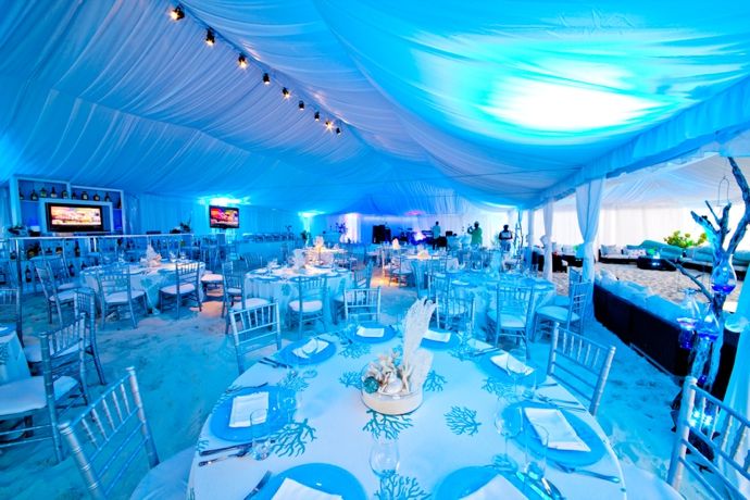 the inside of a tent with tables and chairs set up for an event or party