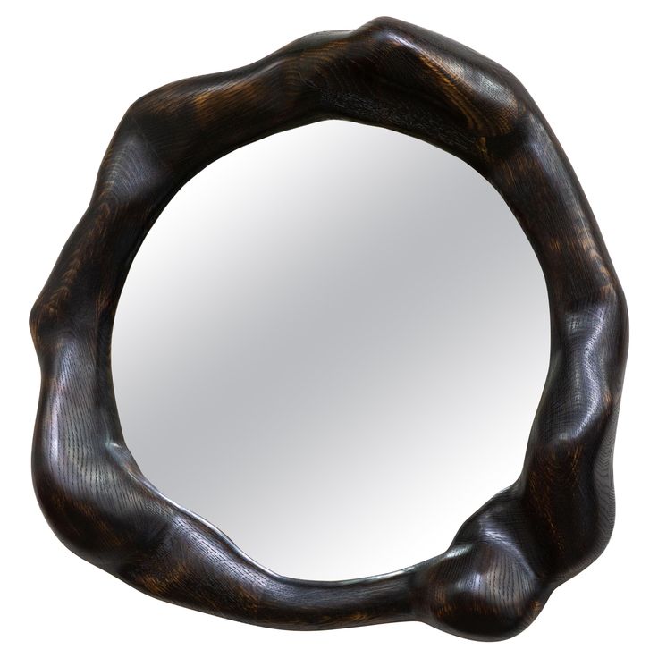 a mirror that is made out of wood and has an oval shaped design on it