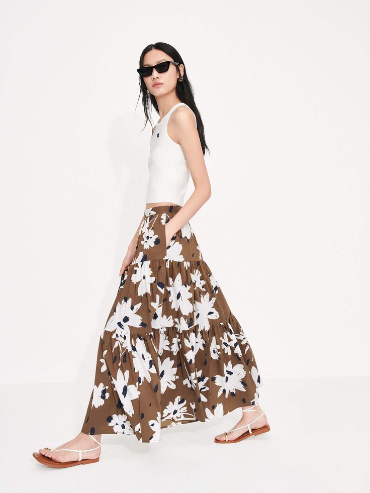 MO&Co. Women's Tiered Floral Print Maxi Skirt This luxurious piece features a feminine maxi length and flowy fit, along with a high waist and pleated design. Plus, a concealed side zipper closure and bold floral print add the finishing touches for a standout look. Features : - Maxi length and flowy fit- High waist and pleated details- Concealed side zipper closure- Floral printed design Code: MBC2SKTT09The back length of size S is 85.5cmMATERIALS & CARE Material: 68.5% Cotton 27.5% Polyamide 4% Floral Print Maxi Skirt, Print Maxi Skirt, Bold Floral Print, Printed Maxi Skirts, Floral Print Maxi, Tropical Islands, Printed Design, Floral Printed, Side Zipper