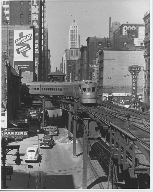 an old black and white photo of a train going down the tracks in new york city