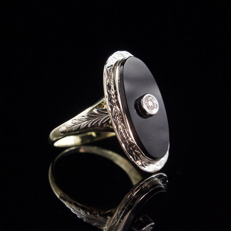 Metal: Solid 14k Yellow and White Gold Stone: 9x18 mm Onyx and a 2mm Diamond Size: 5 Weight: 3.7 grams Era: 1930's This classy ring is white gold on the top and yellow gold on the bottom. Intricately engraved white gold leaves adorn each side of the ring. The oval onyx has a small diamond set in white gold in the center. All of the engraving is still crisp and detailed after all these years. The stone is in very good condition with no eye visible flaws. The interior of the band is stamped with the 14k gold purity stamp. The ring has been professionally cleaned and polished and is ready to wear.  To view our other listings of fine jewelry click here, https://www.etsy.com/shop/seafarevintage?ref=hdr_shop_menu To help make your decision easier, I am always more than happy to take additional p Antique Signet Ring With Polished Finish For Formal Occasions, Classic Formal Engraved Ring With Polished Edges, Classic Black Enamel Signet Ring, Elegant 14k White Gold Signet Ring With Polished Finish, Black Enamel Diamond Anniversary Ring, Elegant Platinum Signet Ring With Polished Finish, Classic White Gold Onyx Rings, Round Black Enamel Diamond Ring For Anniversary, Oval White Gold Jewelry With Black Enamel