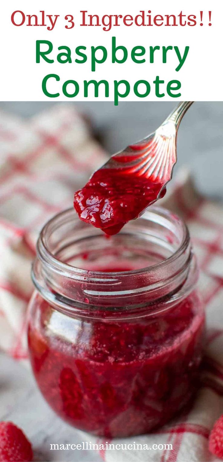 raspberry compote in a glass jar with a spoon