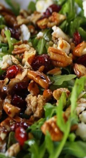 a salad with nuts, cranberries and feta cheese