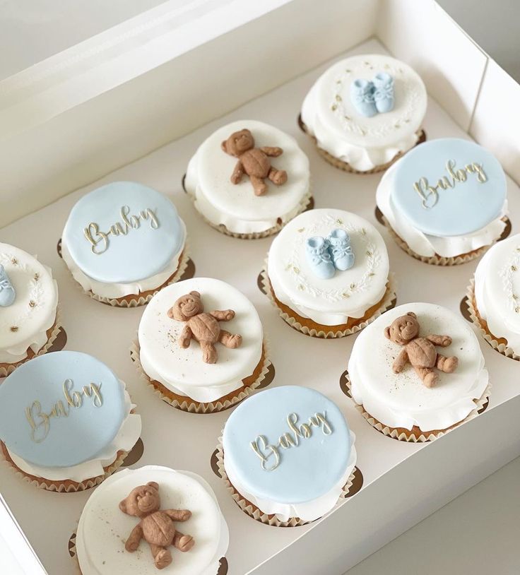 twelve baby cupcakes in a box with teddy bears on them