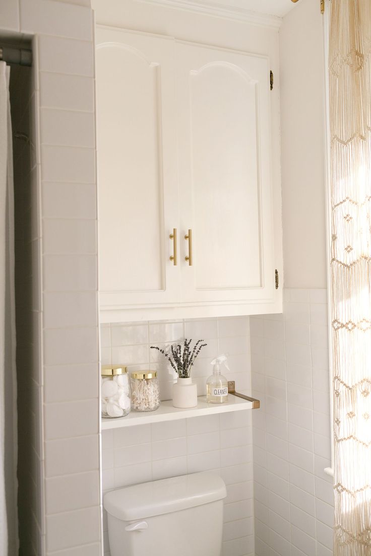 a white toilet sitting in a bathroom next to a shower