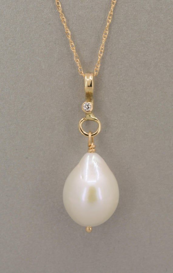 Large white baroque shape freshwater pearl pendant in solid gold.  This classic and timeless piece has a beautiful and luminous high quality natural freshwater pearl with a very smooth surface.  The pearl has a slight teardrop baroque shape and dangles from a 14K solid gold handmade pendant with a diamond also set in 14K gold.  The pendant is shown with two different chains a rope chain and a cable chain.  Both are solid 14K gold and are sold separately. You can also use your own chain.  The bai Anniversary Pearl Charm Drop Jewelry, Graceful Teardrop Jewelry For Anniversary, Yellow Gold Drop Jewelry With Single Diamond, Elegant Teardrop Single Diamond Jewelry, Anniversary Drop Pearl Charm Jewelry, Classic Drop Jewelry With Single Diamond, Drop Jewelry With Single Diamond For Anniversary, Drop-shaped Single Diamond Jewelry For Anniversary, Drop Shaped Single Diamond Jewelry For Anniversary