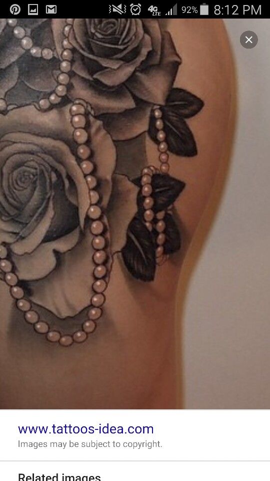 the back of a woman's stomach with roses and pearls on it