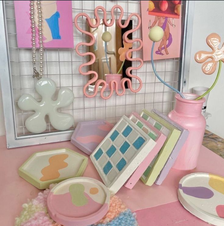 there is a pink table with many items on it