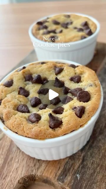 two white dishes filled with chocolate chip cookies