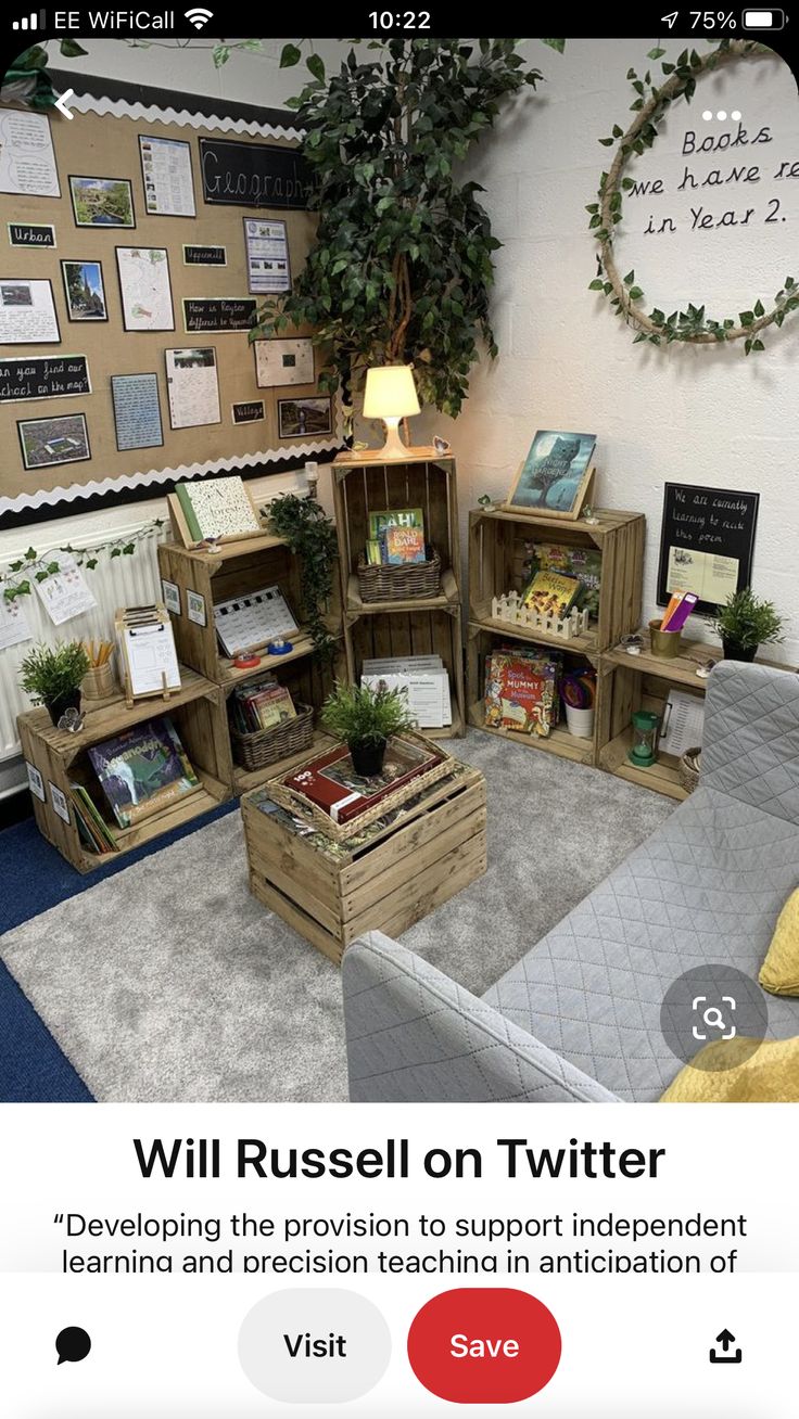 the room is decorated with books and plants in crates on the floor, as well as several other wooden boxes