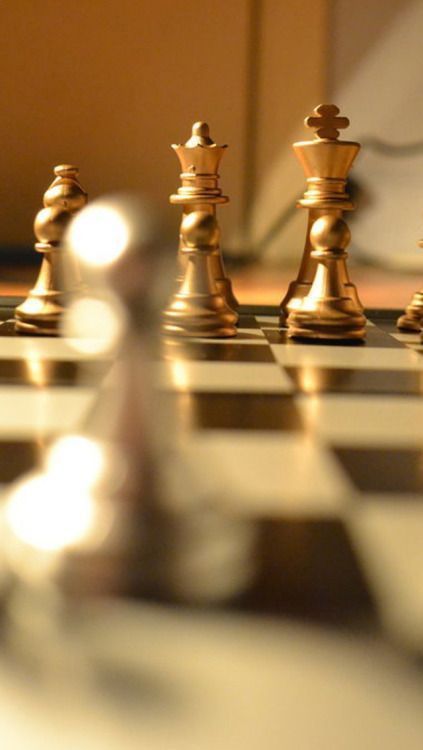 a chess board with gold pieces on it