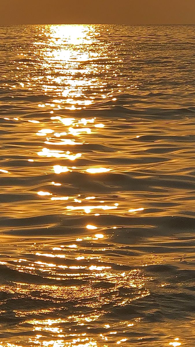 the sun shines brightly on the water as it reflects off the surface of the ocean