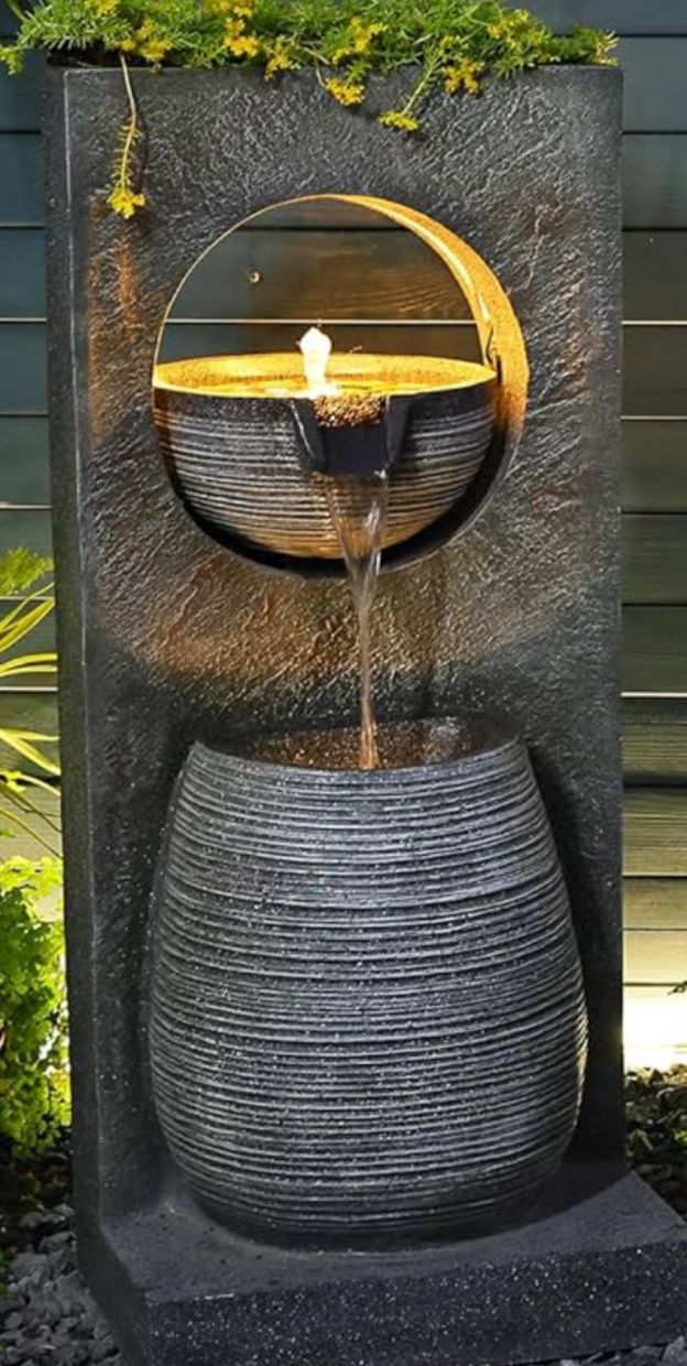 an outdoor fountain with water coming out of it