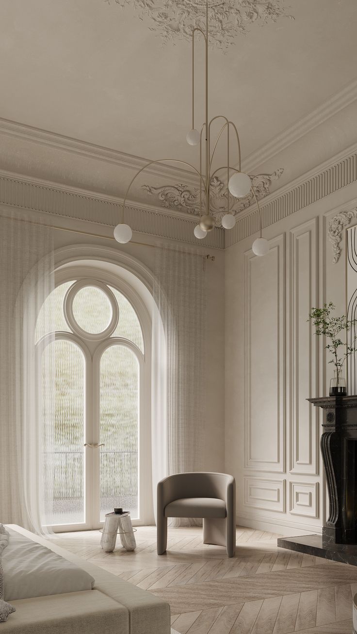 a living room with a couch, chair and fireplace in front of an arched window