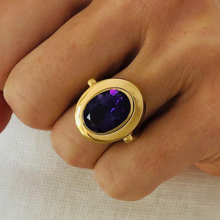 Royal purple, this intense Amethyst Ring is made for a February baby who likes to express herself. Set in 14k Solid Yellow Gold, this classic design and bold color make a statement with a fresh pop of color. 14k Solid Yellow Gold Amethyst 3.10 cts Amethyst approx. 20mm x 16mm Style Note: This one-of-a-kind ring is a size 6.5 and can be sized. Large Sapphire Ring, Large Gemstone Rings, Cocktail Rings Statement, F The World, Amethyst Rings, Amethyst Cocktail Ring, February Baby, Amethyst Ring Vintage, Large Stone Rings