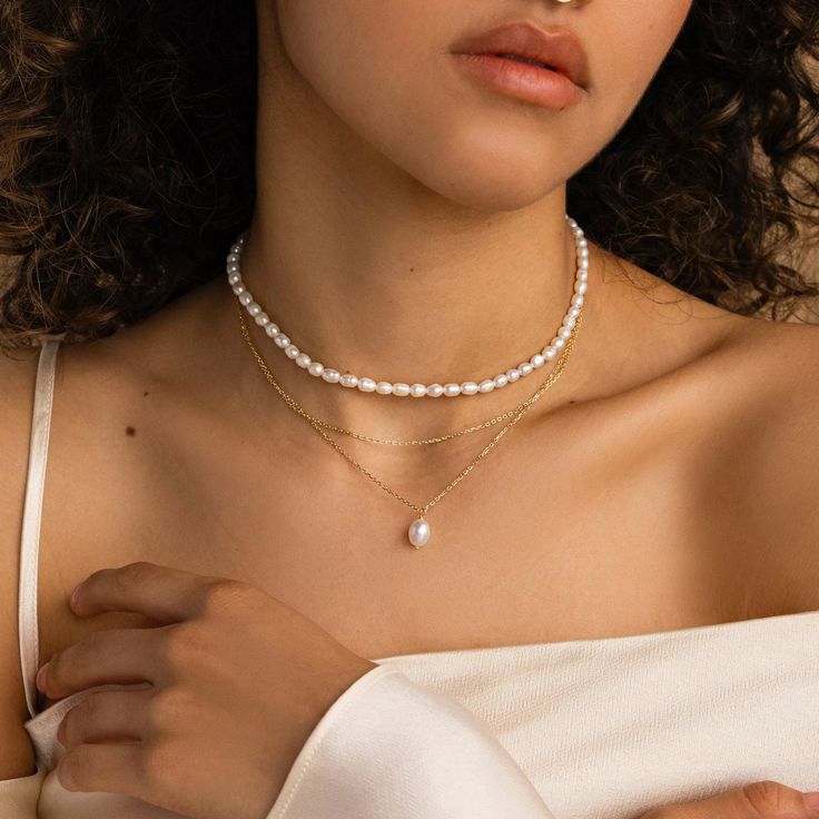 Our Duo Chain Pearl Necklace features a dainty choker paired with a lustrous pearl pendant necklace, creating a seamless layered look in one elegant piece. This unique design combines the timeless beauty of pearls with contemporary styling, perfect for an effortlessly chic, coordinated look that takes the guesswork out of layering. SKU: RR-NR218 Product Details Material: High Quality Solid 925 Sterling Silver Finish: 18K Gold ∙ Sterling Silver Featuring a Layered Pearl Necklace with a ~8.5in Cab Dainty Layered Jewelry, Photoshoot Hair, Art Deco Pendant Necklace, Layered Pearl Necklace, Marquise Diamond Ring, Dainty Choker, Initial Gifts, Quotes Instagram, Stacked Necklaces