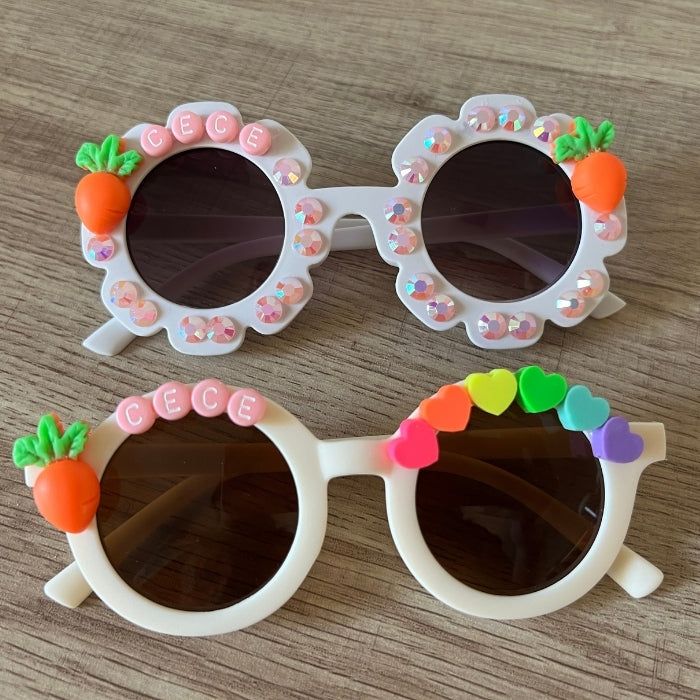 Personalized kids Easter carrot sunnies for some springtime cheer. These make the cutest Easter accessory or basket stuffer. Sunnies fit children around age 2-10. TO ORDER:There are a few ways to customize the sunglass style, beads, and colors: Select Bead Design: There is a wide selection of beads to choose from. Reference picture for options. Add Sparkle: Option to add pearls or rhinestones around the lenses, or no sparkle. Reference picture for options. Select Name Bead Color: Choose between Cute White Plastic Sunglasses, Playful Multicolor Sunglasses For Spring, Playful White Sunglasses For Gift, Playful White Sunglasses For Gifts, Playful White Sunglasses As Gift, White Plastic Sunglasses For Gift, White Plastic Sunglasses As Gift, Cute White Sunglasses For Gift, Fun White Adjustable Sunglasses