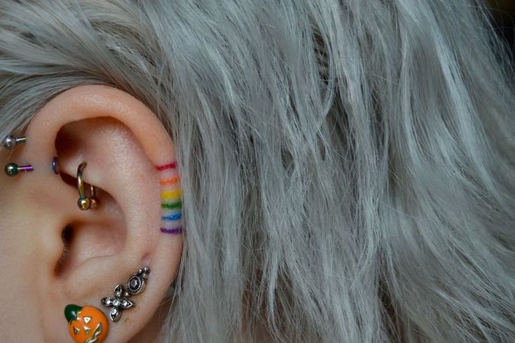 an ear with some piercings attached to it