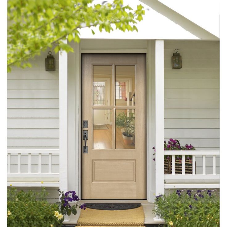 the front door of a house with flowers and plants