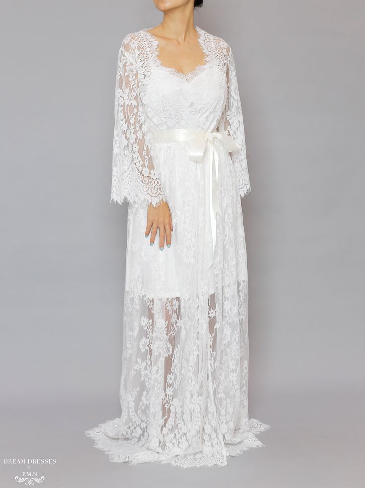 Floor length bridal lace robe with Chantilly French lace Length: 160 cm / 62 in Loose-fitting Bell sleeves Silky ribbon belt Scalloped neckline, lace cuffs and hemline Model is 160 cm/ 5'3'' and wearing a size S Lace Bridal Robe, Scalloped Neckline, Bridal Robe, Dream Dresses, Lace Cuffs, Ultra Feminine, Ribbon Belt, Lace Bridal, Bridal Robes