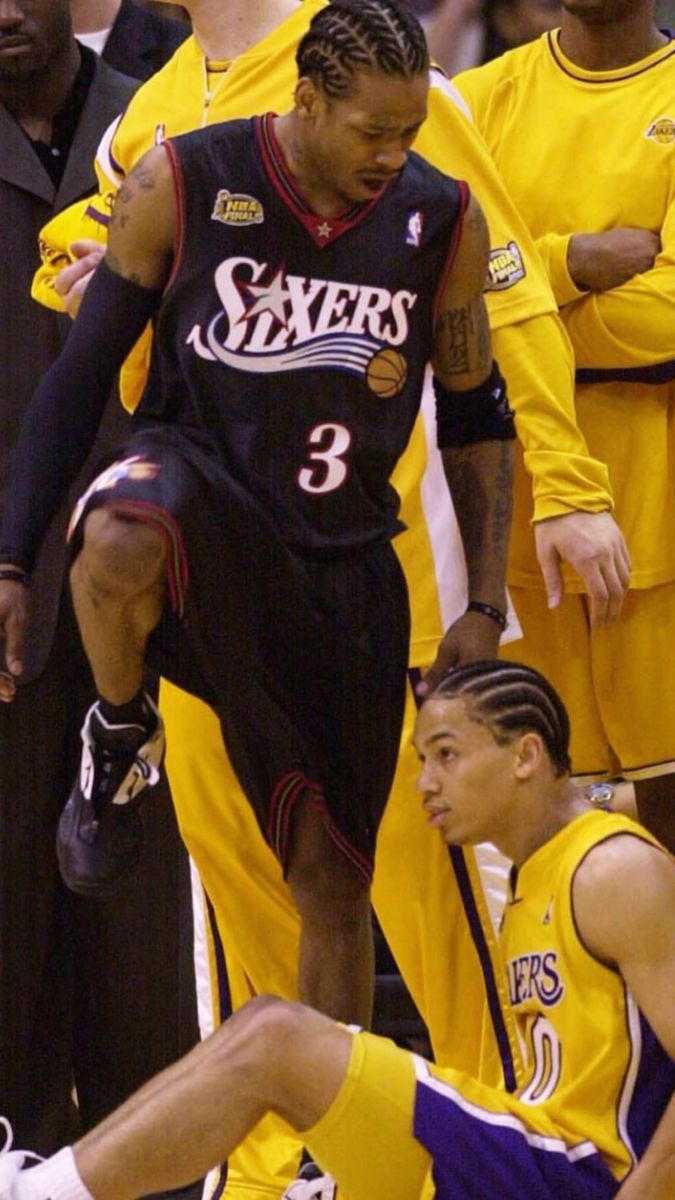 the basketball players are sitting on the floor with their feet in the air as they look at each other