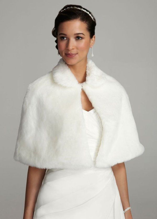 a woman in a white dress and fur stole