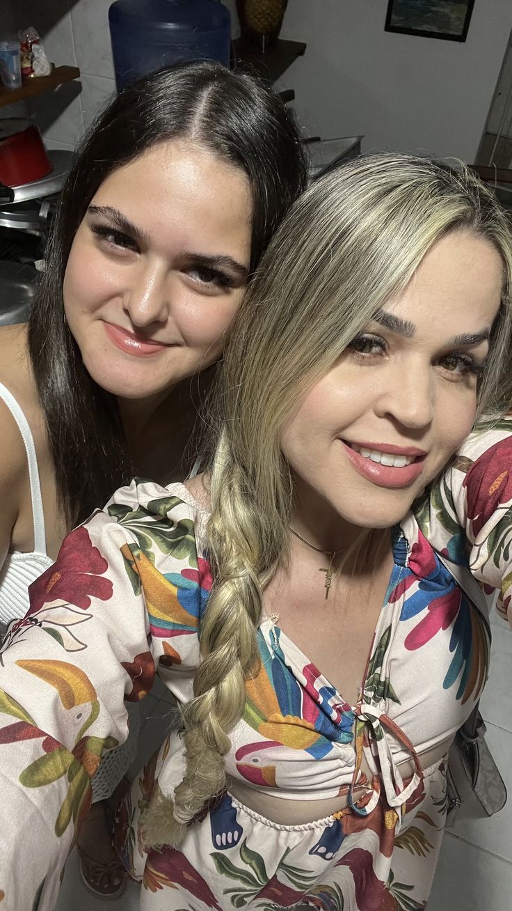 two women with braids posing for the camera