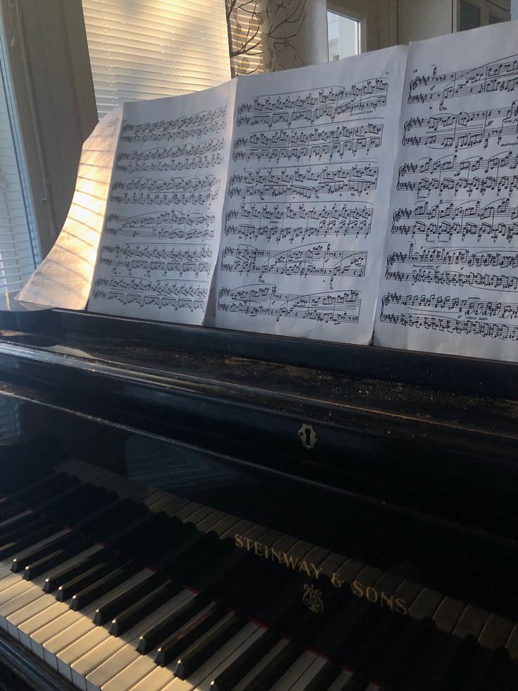 sheet music sitting on top of a piano