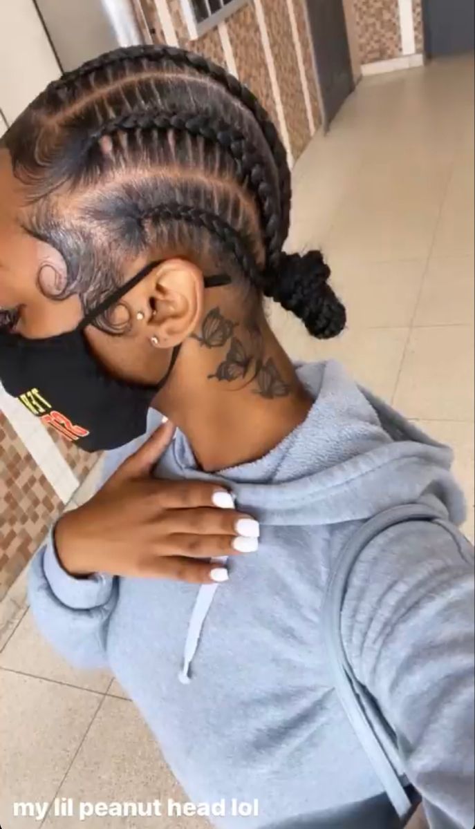 a woman with braids on her head hugging another woman