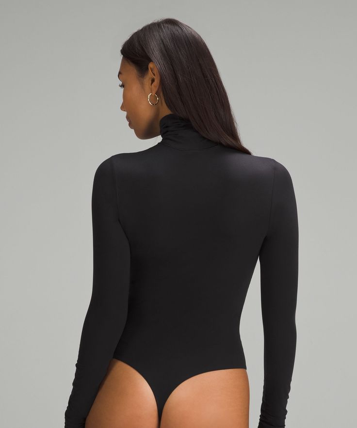 A Luxurious Second Skin. Made From A Peach-Fuzz Soft Version Of Our Nulu Fabric, This Turtleneck Bodysuit Can Be Worn On Its Own And Is Streamlined Enough To Layer. Designed For Casual. Fabric Is Double Layered For Coverage, Support, And A Seriously Soft Feel On Both Sides. The Sleeves Have A Single Layer Of Fabric:contours Your Body With A Fit That Feels Snug. For A More Gentle Feel, Opt For A Size Up:thong Cut:xs = Lululemon Size 4, S = Lululemon Size 6, M = Lululemon Size 8, L = Lululemon Siz Fitted Lululemon Tops With Thumbholes, Fitted High Neck Bodysuit With Lined Body, Fitted High Neck Elastane Leotard, Elegant Long Sleeve Stretch Swimwear, Turtleneck Bodysuit, Bodysuit Designs, Peach Fuzz, Womens Long Sleeve Shirts, Lululemon Women