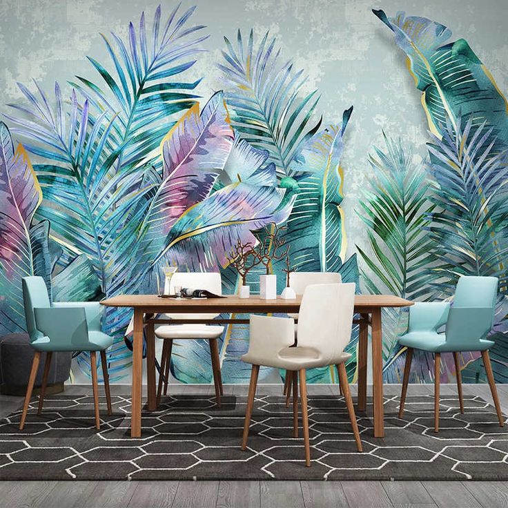 a dining room with tropical wallpaper and blue chairs in front of a wooden table