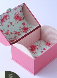 an open pink box sitting on top of a table